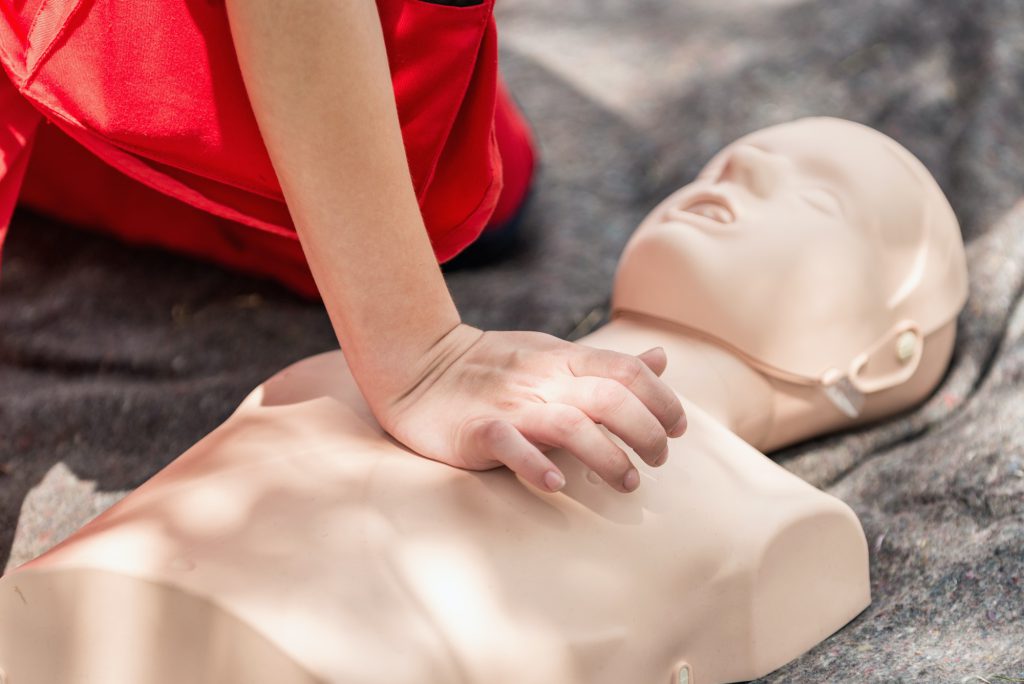 Cpr training outdoors. Reanimation procedure on CPR doll